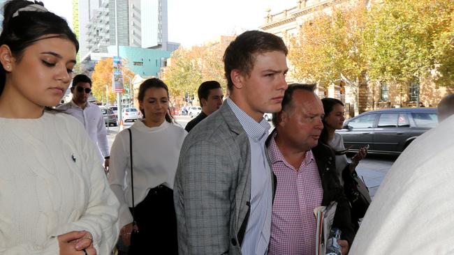 Reece Watherston leaves the Supreme Court with supporters on Monday after taking to the stand. Picture: AAP / Kelly Barnes