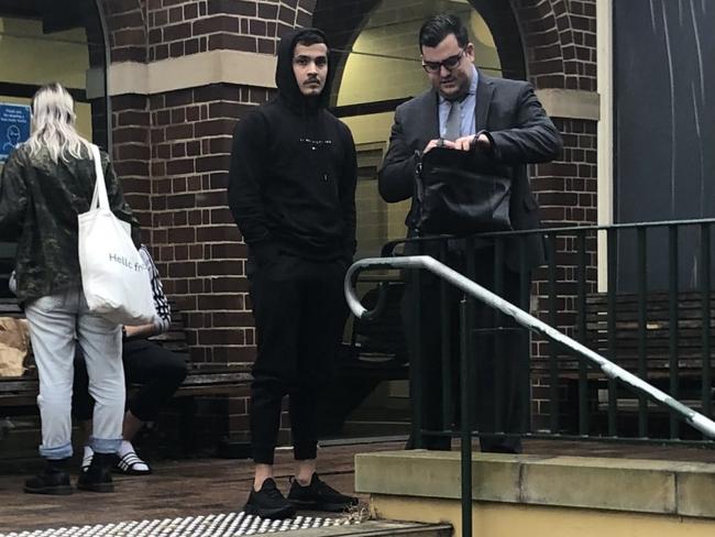 Ali Reza Bahrami (centre), 20, of Auburn, leaving Manly Courthouse on Wednesday with his lawyer. Picture: Manly Daily