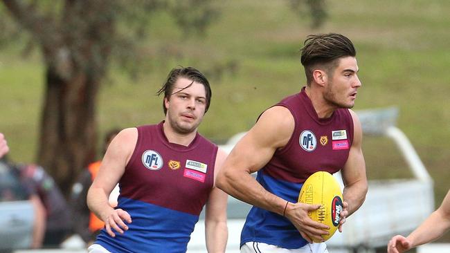 James Kroussoratis of Banyule (right) runs off Ben Weissenfeld of Watsonia (left) during NFL footy: Watsonia v Banyule on Saturday, May 12, 2018, in Watsonia, Victoria, Australia. Picture: Hamish Blair