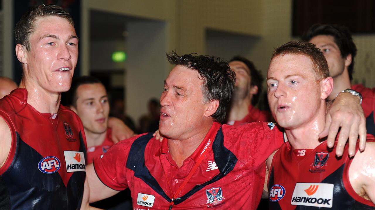 Todd Viney sings the song with the Melbourne players after coaching his first win.