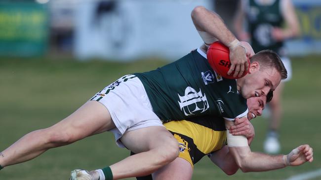 Rochester’s Hugh Hamilton lays a strong tackle on Echuca’s Logan Prout.