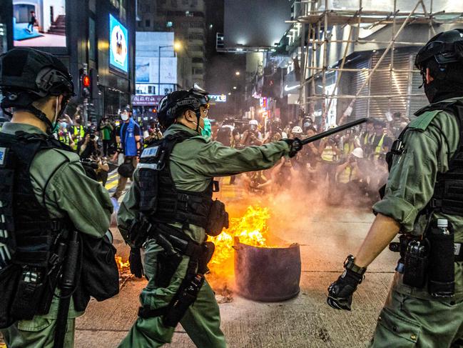 Police stand guard on a road to deter pro-democracy protesters from blocking roads. Picture: AFP