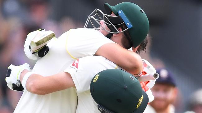 Mitchell Marsh, (left) celebrates his century with captain Steve Smith.