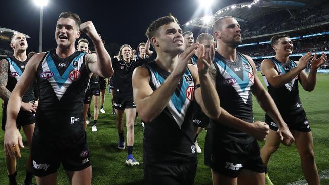 Tom Rockliff, Karl Amon and Travis Boak celebrate after the qualifying final win.