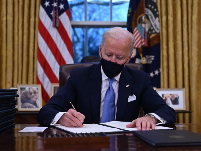 Joe Biden got straight to work, signing off on more than a dozen executive orders. Picture: AFP