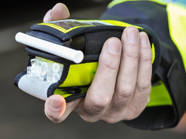 Belfast, Northern Ireland. 24 Nov 2016 - A police officer holds a roadside breathalyser alcohol breath test after taking a sample from a driver.