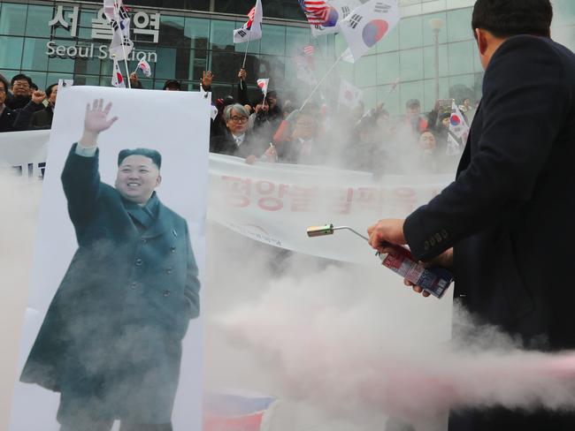 South Korean protesters denounce the unification flag and Kim Jong-un during a rally in Seoul. Picture: Yonhap/AFP