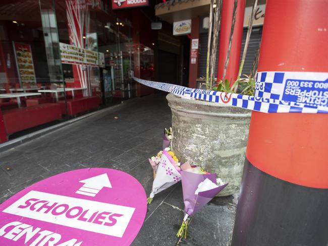 Flowers were laid at the food court that was cordoned off after the tragedy. Picture: Nigel Hallett