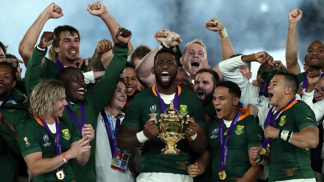 South Africa captain Siya Kolisi celebrates with his team and the Rugby World Cup trophy after their victory over England in Yokohama. Picture: Getty Images