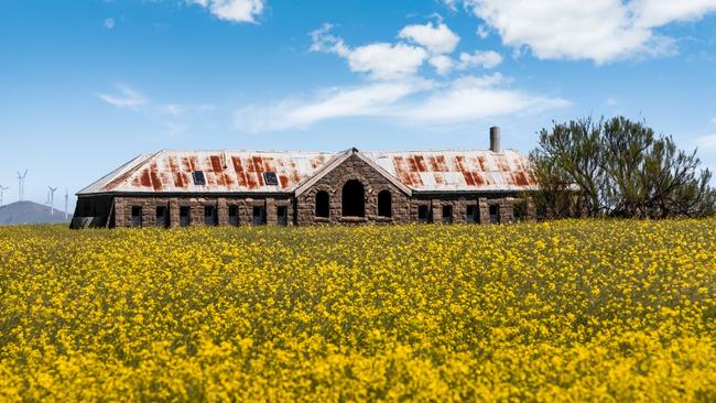 A historic bluestone shearing shed stands at the Eurambeen Station farmland.