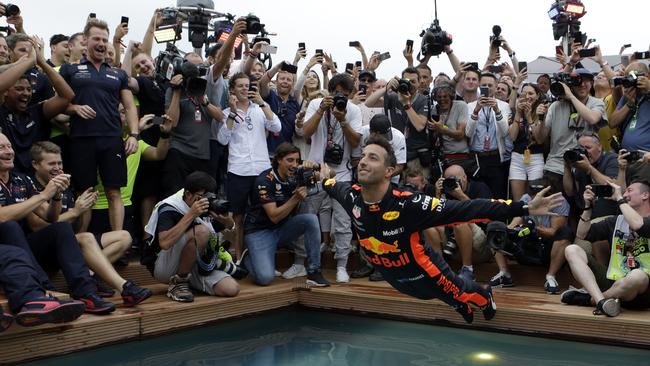 Aussie Red Bull driver Daniel Ricciardo dives into a pool to celebrate his Monaco GP win. Picture: AP/Claude Paris