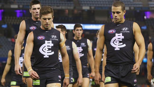 Marc Murphy leads his team off after losing to Gold Coast.