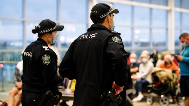 Police at the arrivals section in Adelaide Airport Picture: The Advertiser / Morgan Sette