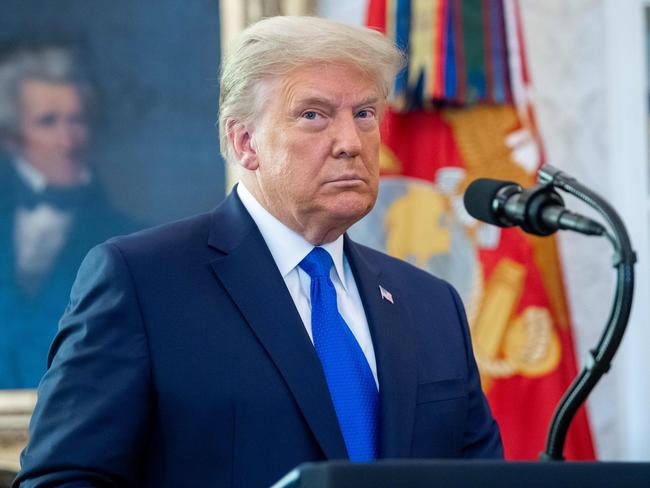 TOPSHOT - US President Donald Trump looks on during a ceremony presenting the Presidential Medal of Freedom to wrestler Dan Gable in the Oval Office of the White House in Washington, DC on December 7, 2020. (Photo by SAUL LOEB / AFP)