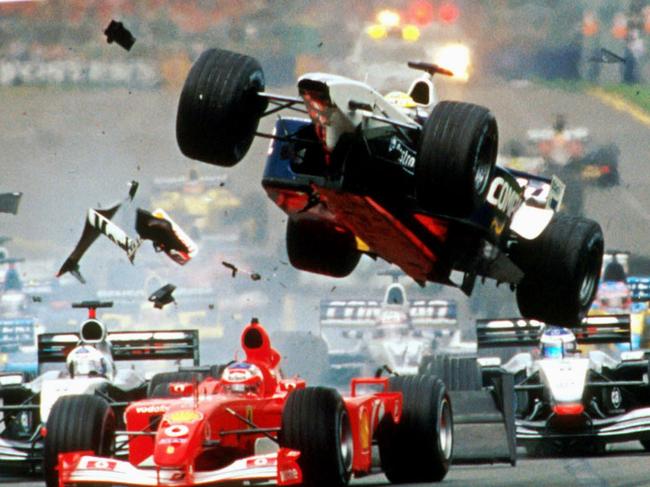 03/03/2002. The Williams of Ralf Schumacher of Germany, center, flies over the Ferrari of Brazil's Rubens Barrichello as they collide while heading for the first corner of the first lap of the Australian Formula One Grand Prix.  (AP Photo/Australian Grand Prix Corp., Joe Mann)