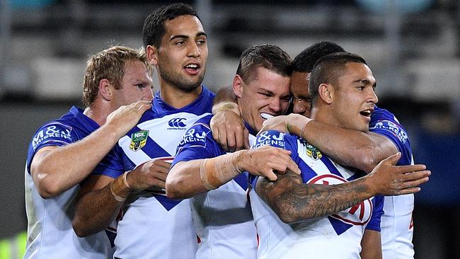 Kerrod Holland (centre) celebrates a try with teammates. Picture: AAP