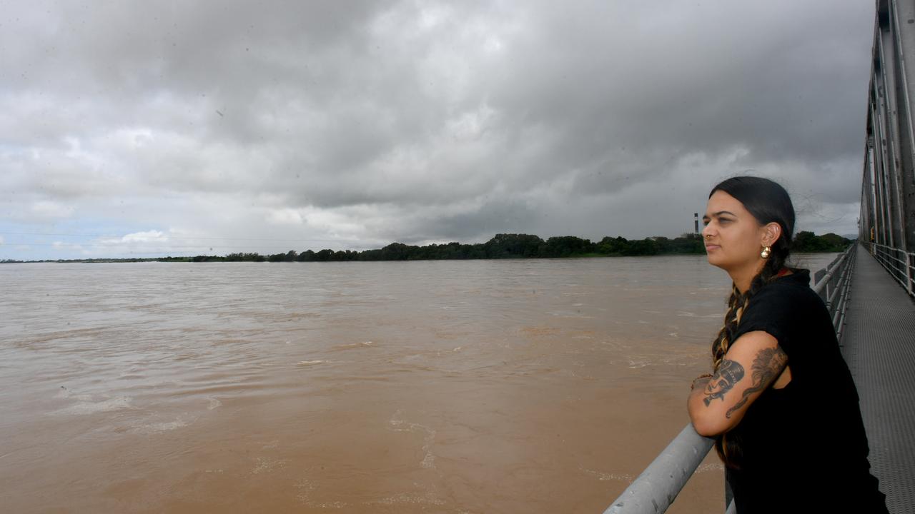 Townsville Bulletin journalist Nikita McGuire on the Burdekin Bridge at Ayr looks at the vast amount of water flowing down the river. Picture: Evan Morgan