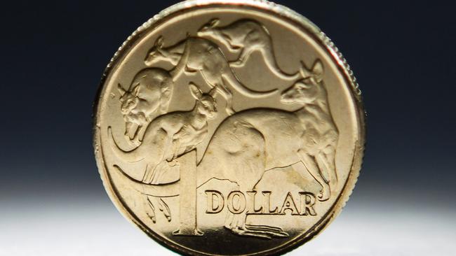 An Australian one-dollar coin is arranged for a photograph in Sydney, Australia, on Wednesday, April 17, 2013. Direct trading between the Australian dollar and yuan started on April 10. Photographer: Ian Waldie/Bloomberg