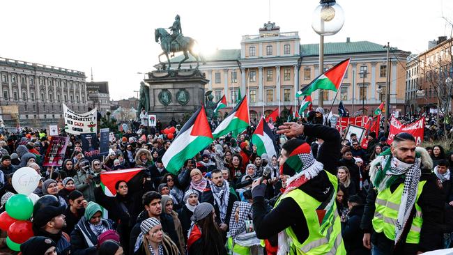 Pro-Palestinian supporters wave flags and carry placards during a demonstration organized by 'Together for Palestine' with demands for cease-fire and to exclude Israel from the Eurovision Song Contest, in central Stockholm. Picture: Fredrik Persson/AFP