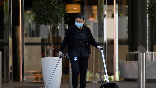 A cleaner wears a face mask while sweeping at the Sydney Harbour Marriott Hotel in Sydney. Picture: NCA NewsWire/Bianca De Marchi