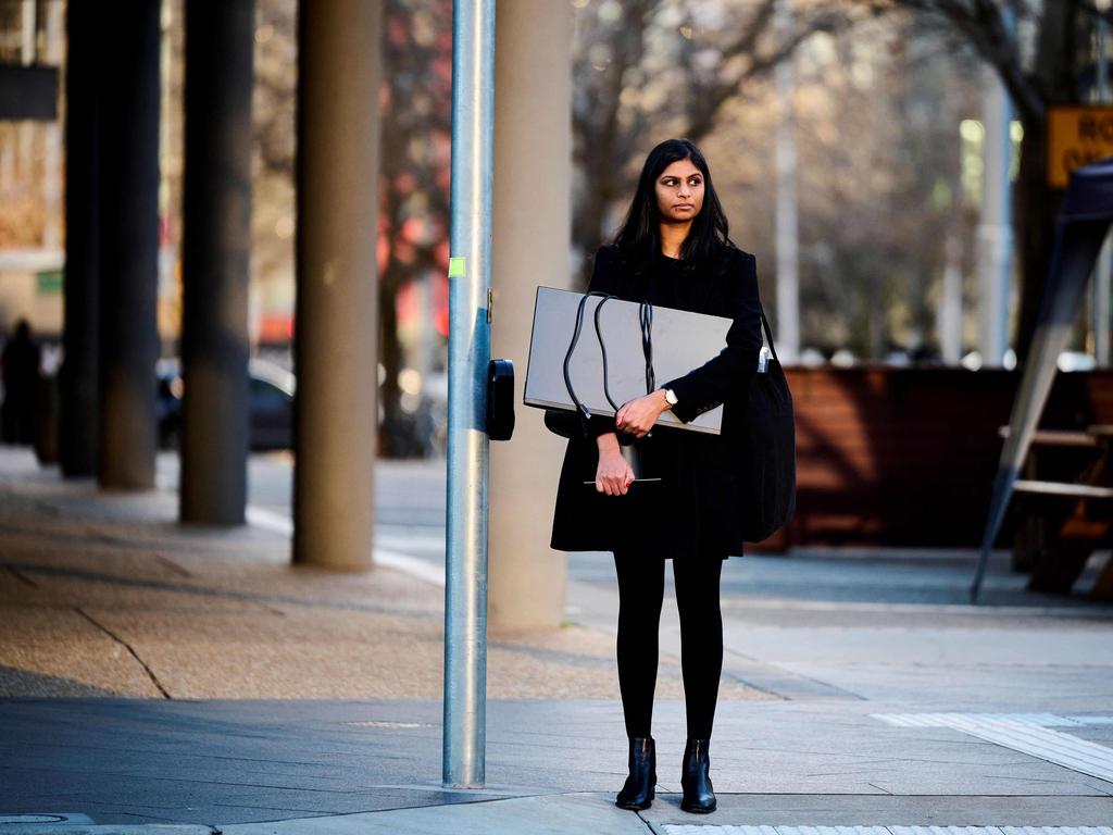 A woman carries a computer monitor to work from home in 2021. Picture: Rohan Thomson/AFP