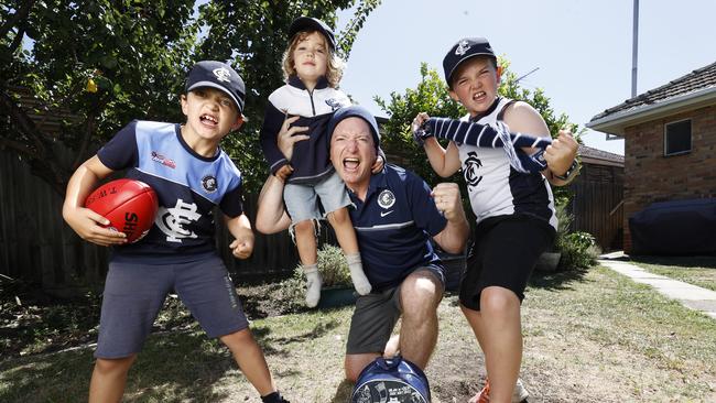 Stephen and his sons Edoardo, 9, Guilio, 3, and Lucio, 11, are looking forward to the 2022 AFL season. Picture: Alex Coppel