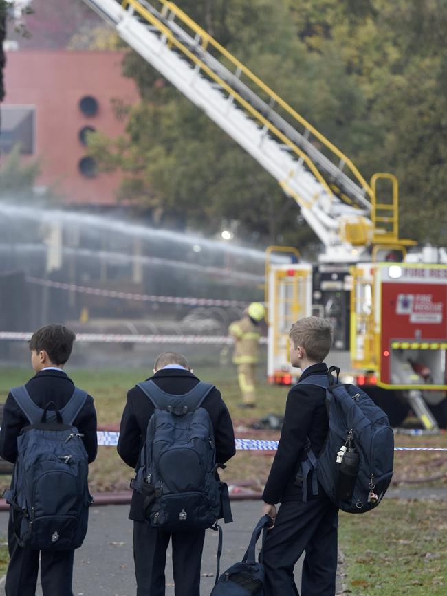 Students watch on as fire crews mop up. Picture: Andrew Henshaw