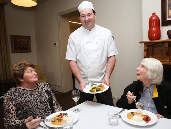 Ashley Thomson serves food to Shirley and Pam.