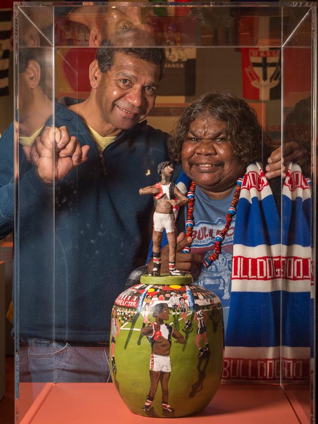 Gilbert McAdams and artist Rona Panangka Rubuntja check out iconic indigenous moments in footy at the Hermannsburg Potters in the Northern Territory. Rona is a member of the Hermannsburg Potters. Picture: Jake Nowakowski