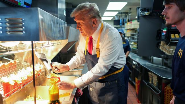 Donald Trump works behind the counter during a visit to McDonald's in Pennsylvania. Picture: Getty Images.