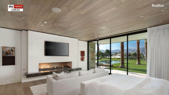 A bedroom with a fireplace and mountain vistas. Picture: Realtor