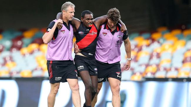 Irving Mosquito is helped from the field after injuring his knee against Geelong.