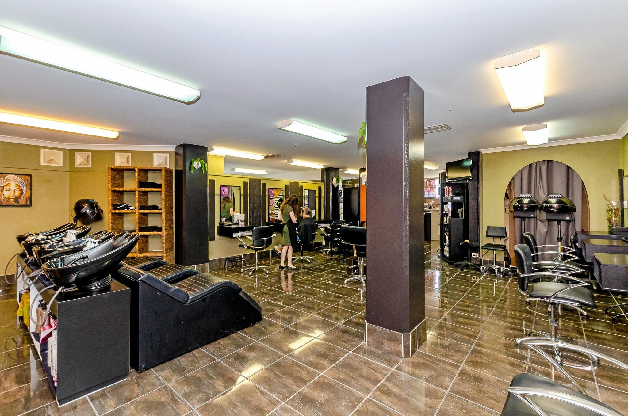 LJ Hooker has listed 81 Goondoon St, where Commonwealth Bank, Uber Hair and Hello World are, for sale.
