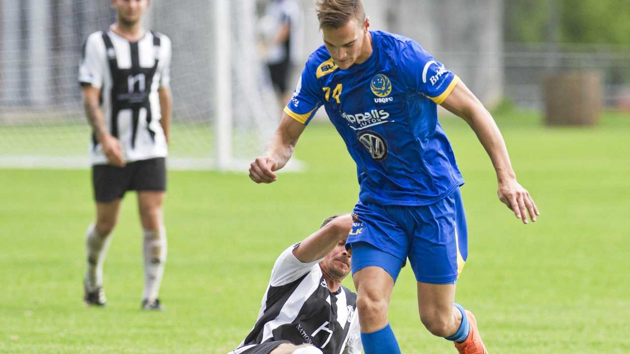 UNDER PRESSURE: Willowburn's Peter Millican slides in on USQ's Daniel Fuller. Picture: Nev Madsen