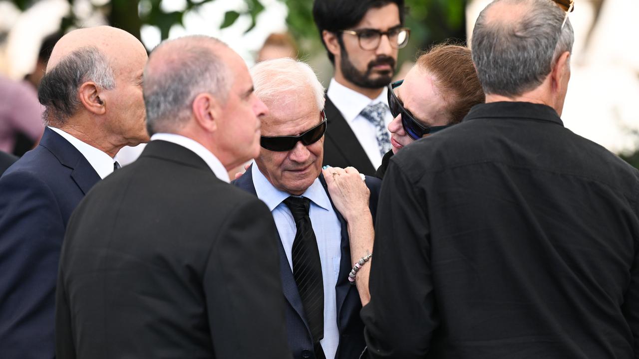 Victor White (centre), the husband of slain grandmother Vyleen White, is supported by mourners after her memorial service. Picture: Dan Peled / NCA Newswire