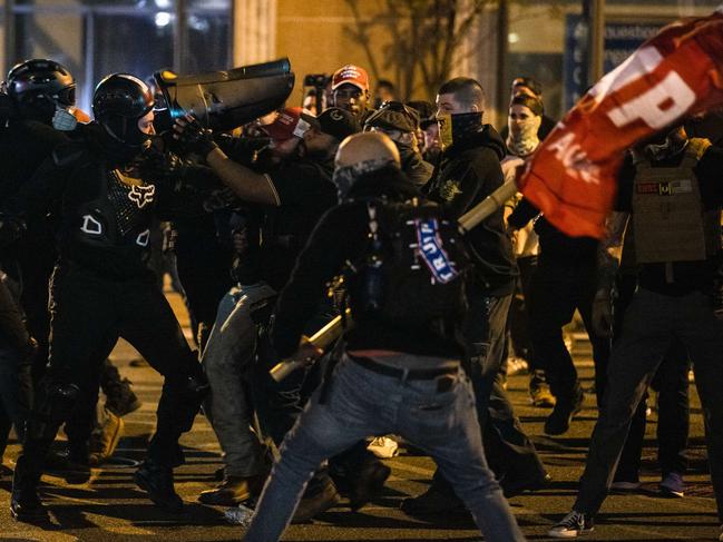 Members of Antifa and Proud Boys clash in the middle of the street following the "Million MAGA March" in Washington, DC. Picture: Samuel Corum/Getty Images/AFP