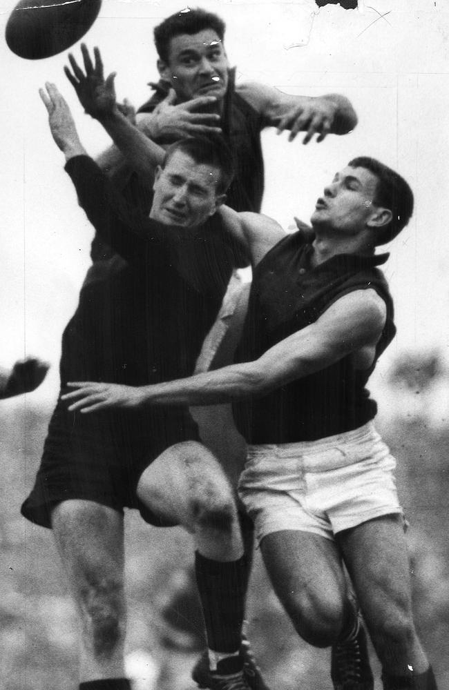 Ron Barassi leaps over Ray Groom and Paul Doran in 1963.