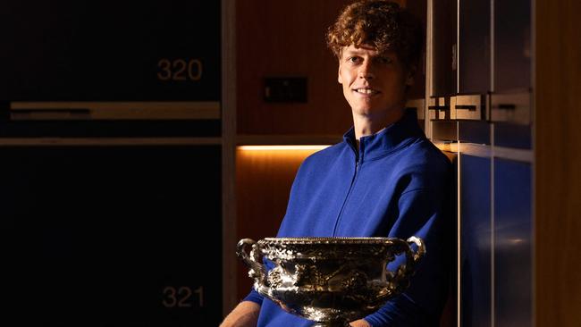 This handout picture released by Tennis Australia on January 27, 2025, shows Italy's Jannik Sinner poses with the Norman Brookes Challenge Cup trophy in a locker room after defeating Germany's Alexander Zverev during their men's singles final match on day fifteen of the Australian Open tennis tournament in Melbourne. (Photo by Fiona HAMILTON / AFP) / RESTRICTED TO EDITORIAL USE - MANDATORY CREDIT "AFP PHOTO / TENNIS AUSTRALIA / FIONA HAMILTON " - NO MARKETING NO ADVERTISING CAMPAIGNS - DISTRIBUTED AS A SERVICE TO CLIENTS