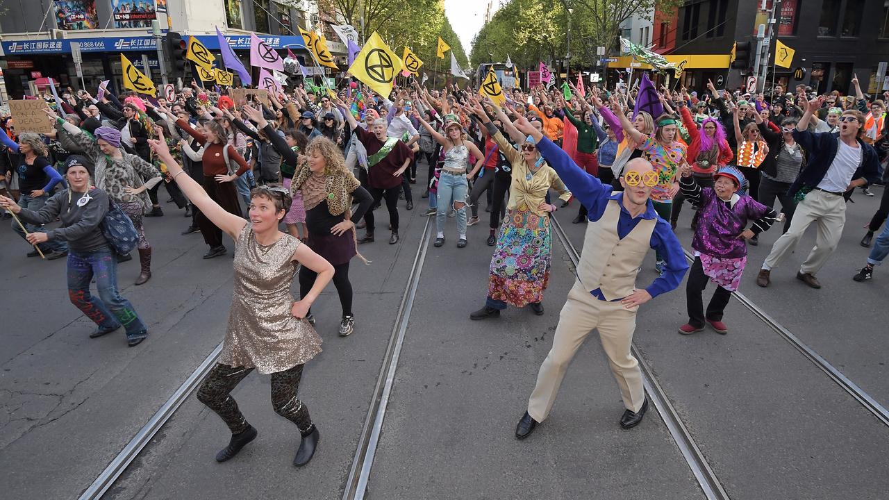 Climate activists dancing through Melbourne streets. Picture: Jason Edwards