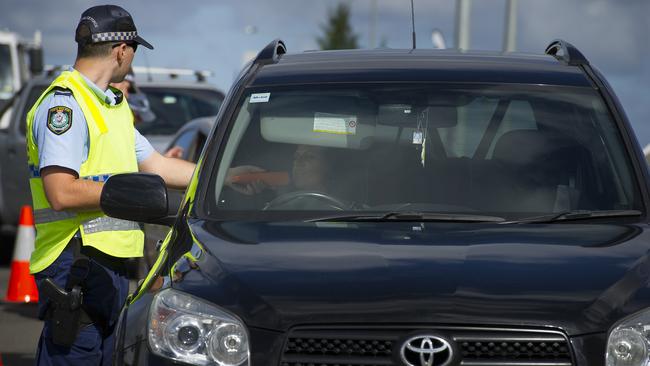 A police officer performs a random breath test.