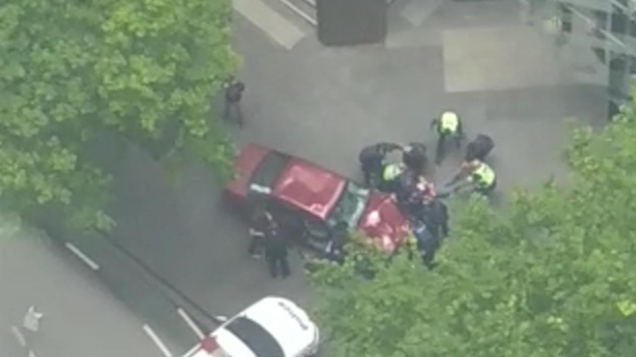 A person is pulled from a crashed car   