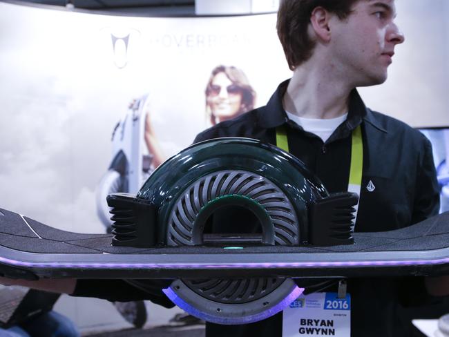 Hoverboard representative Brynn Gwynn holds a Hoverboard at CES International Thursday, Jan. 7, 2016, in Las Vegas. (AP Photo/Gregory Bull)