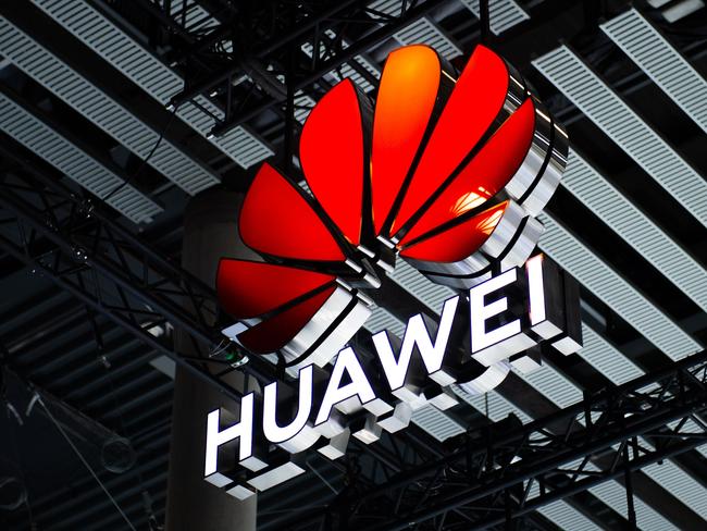 BARCELONA, SPAIN - FEBRUARY 28: A logo sits illuminated outside the Huawei booth at the SK telecom booth on day 1 of the GSMA Mobile World Congress on February 28, 2022 in Barcelona, Spain. The annual Mobile World Congress hosts some of the world's largest communications companies, with many unveiling their latest phones and wearables gadgets like foldable screens.  (Photo by David Ramos/Getty Images)