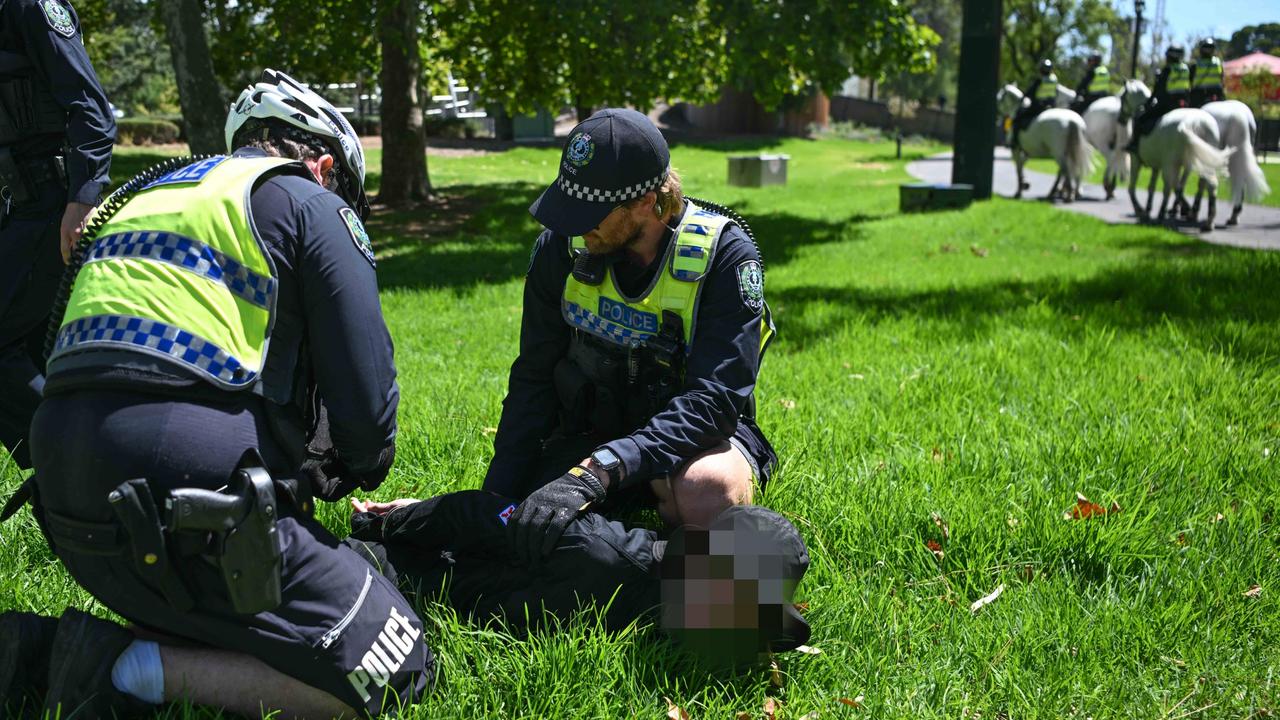 Police arrest one of the 16 men. Picture: Tracey Nearmy/Getty Images