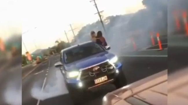 Alleged car thieves in a Toyota HiLux do burnouts and run a red light outside Pillow Talk on McCoombe St earlier this year.