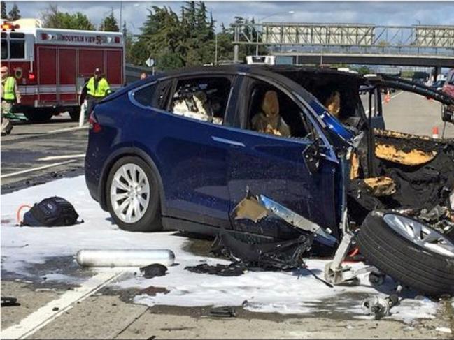 FILE - In this March 23, 2018, file photo provided by KTVU, emergency personnel work a the scene where a Tesla electric SUV crashed into a barrier on U.S. Highway 101 in Mountain View, Calif. The Apple engineer who died when his Tesla Model X crashed into the concrete barrier complained before his death that the SUVâ€™s Autopilot system would malfunction in the area where the crash happened. The complaints were detailed in a trove of documents released Tuesday, Feb. 11, 2020, by the U.S. National Transportation Safety Board, which is investigating the March, 2018 crash that killed engineer Walter Huang.  (KTVU-TV via AP, File)