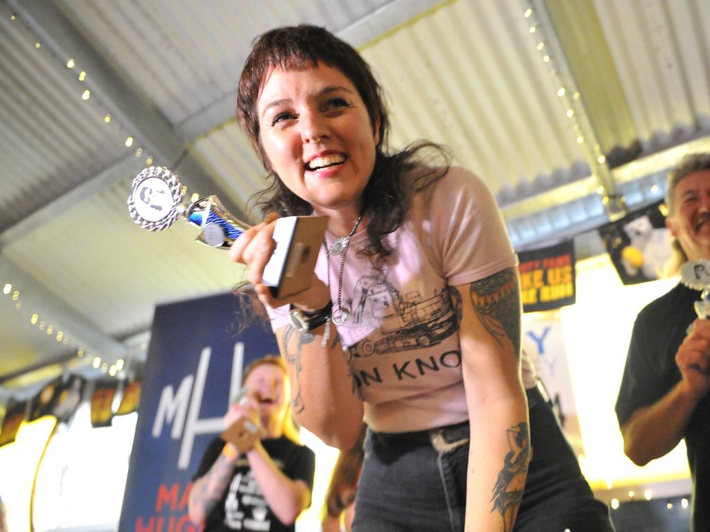 Michelle "Darlzy" Gearin celebrates winning the best mullet competition during Mulletfest, a special event designed to celebrate the hairstyle that's all about business at the front, party at the back, at Chelmsford Hotel in Kurri Kurri, NSW. (AAP Image/Perry Duffin) 