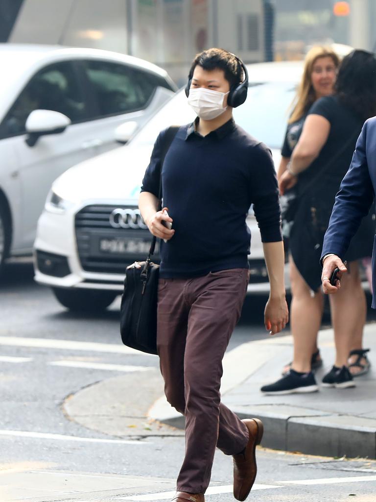 As smoke from bushfires engulfs Sydney, morning commuters are pictured wearing face masks as they make their way to work. Picture: MATRIX