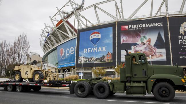 Equipment is driven by the National Guard as it sets up for coronavirus testing in Washington. Picture: AP