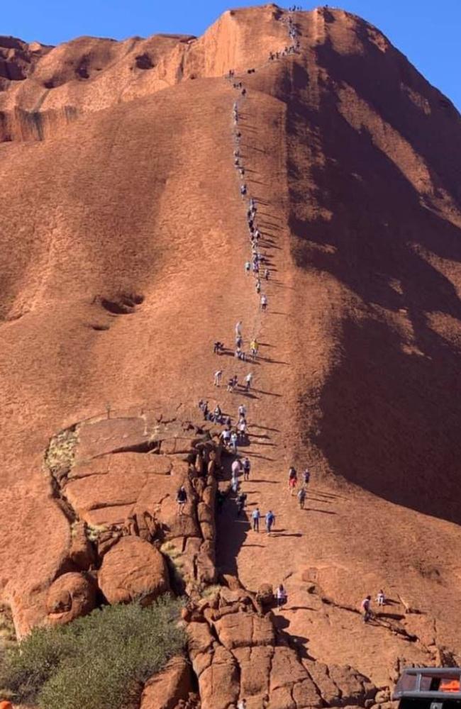 The picture showed dozens of people scaling Uluru.